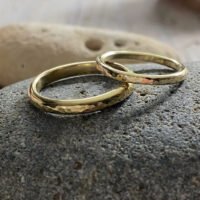 Awyr and seren recycled gold textured d-shaped wedding rings